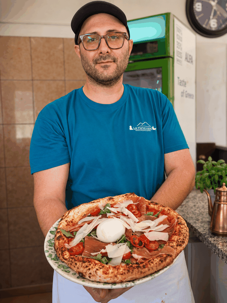 Owner and pizzaiolo of La Partenope by the wood-fired oven in Corfu