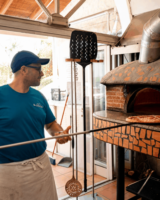 La Partenope pizza chef working with the wood fired oven